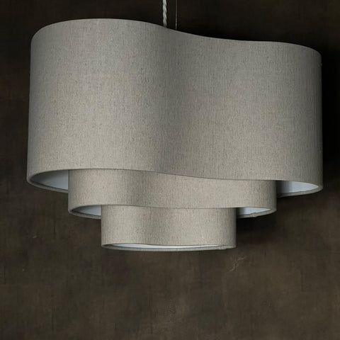 a beige 3 tiered lampshade in an unusual kidney shape