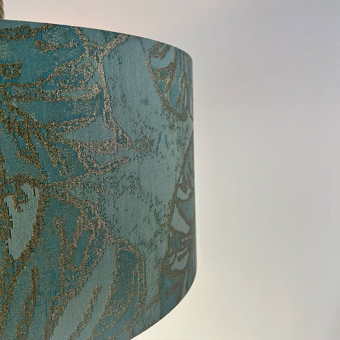 Crafted from premium peacock blue jacquard fabric, this drum lampshade has a soft texture, perfect for any modern or traditional interior design.