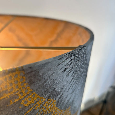 Sophisticated and stylish, the Assam Pepperpod Silver Drum Lampshade features a shimmering silver jacquard fabric with intricate detailing, finished with a frosted inner lining and beach gold frame.