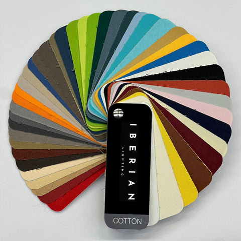 A set of fabric sample swatches in various colors spread out with the brand name 'IBERIAN' visible on one of the swatches labeled 'COTTON'.