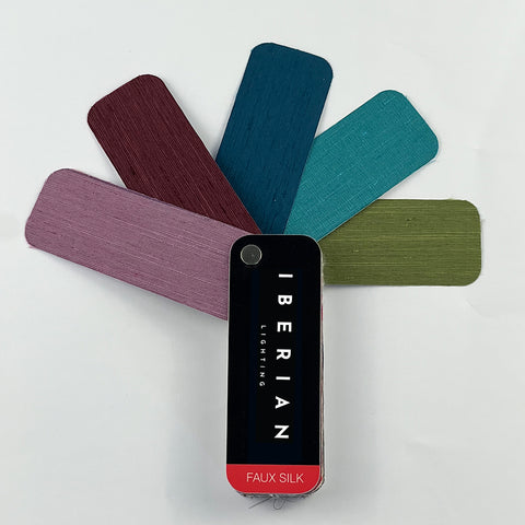 A set of fabric sample swatches in various colors spread out with the brand name 'IBERIAN' visible on one of the swatches labeled 'COTTON'.