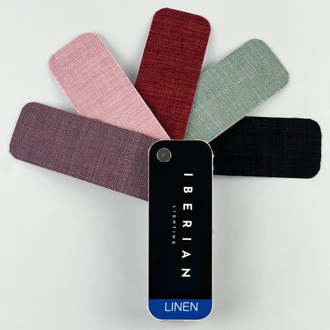 A set of fabric sample swatches in various colors spread out with the brand name 'IBERIAN' visible on one of the swatches labeled 'COTTON'.