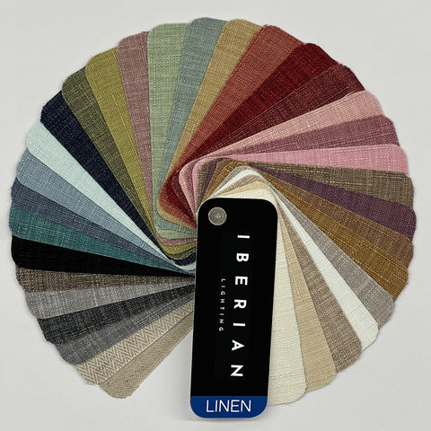 A set of fabric sample swatches in various colors spread out with the brand name 'IBERIAN' visible on one of the swatches labeled 'COTTON'.
