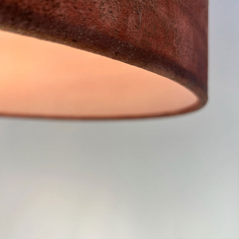 a close-up of velvet rich copper brown velvet fabric with gold highlights on a handmade lampshade, showing a frosted clear inner lining; complements Pantone’s 2025 Colour of the Year, Mocha Mousse.