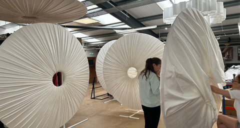 Behind the scenes at Iberian Lighting studio. Lampshade makers hand sewing the oversized canopy lampshades 