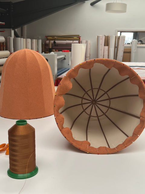 Dome shades in earthen coloured linen work in progress in lampshade makers workshop